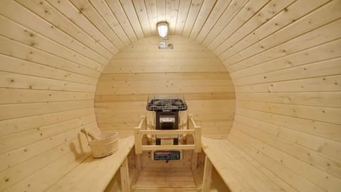 Unwind in your private barrel sauna—warm wood, deep relaxation, and the perfect après-adventure reset.