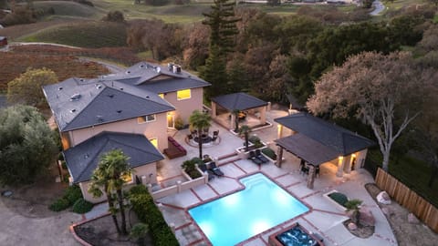 Bird’s-eye view of the illuminated pool and courtyard. (Main house)
