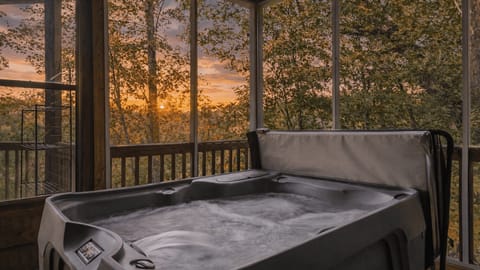 Private screened hot tub with peaceful wooded views.