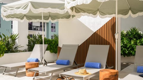 Oversized umbrellas and plush loungers await on the sun deck.