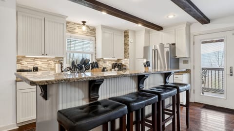 Modern kitchen island with granite countertops and breakfast bar seating