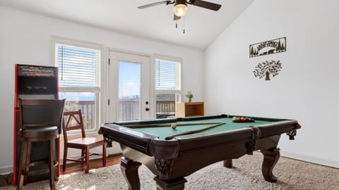Loft game room area featuring a full-sized billiard table and vaulted ceilings.