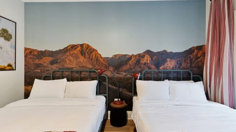 Bedroom 3 (Big Bend NP Themed) features 2 queen beds and an ensuite bathroom. (The Lodge)