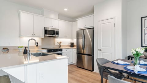 Elegant shaker-style cabinetry and sleek countertops offer both beauty and functionality.