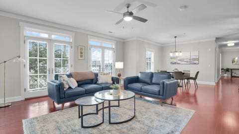 Spacious open living and dining area with modern décor, large windows, and natural light.