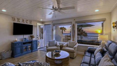 Sun-drenched living room with panoramic ocean views and comfortable seating.