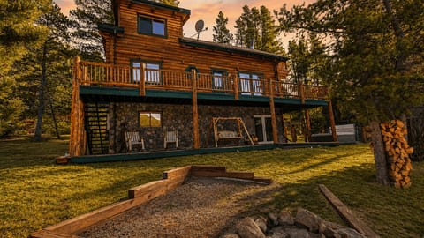 Escape to this classic mountain log cabin featuring expansive decks, peaceful alpine surroundings, and stunning Rocky Mountain views.