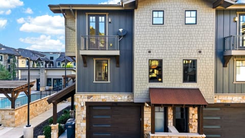 Clean daytime facade view showing the modern garage door and main entryway layout.