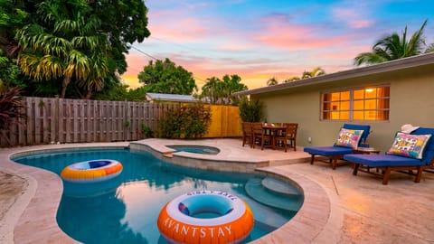 Float, lounge, and dine beside the private pool as the sunset colors the tropical backyard.