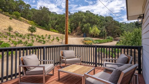 Cushioned deck seating overlooks the hillside.