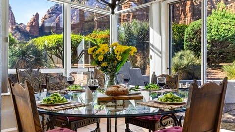 Share meals around the glass-top dining table with panoramic red-rock scenery just beyond the windows.