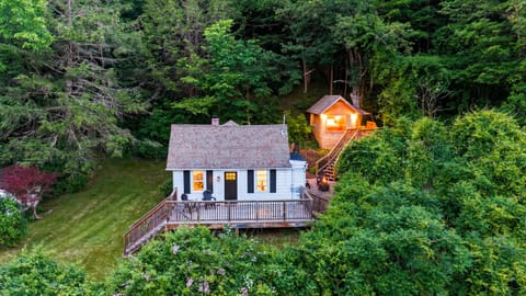 Secluded cottage retreat tucked into the trees with a spacious deck and peaceful wooded surroundings.