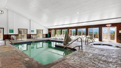 Swim or soak year-round in the indoor pool and hot tub, with mountain views visible just beyond the windows.