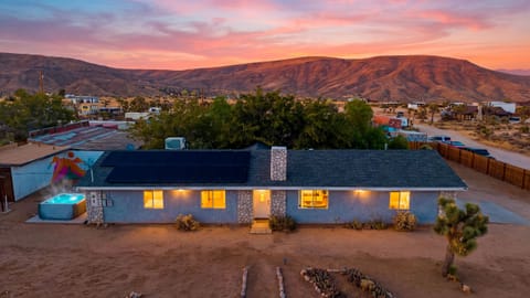 Rawhide Ranch glows at dusk, a private desert retreat framed by open land and mountain views.