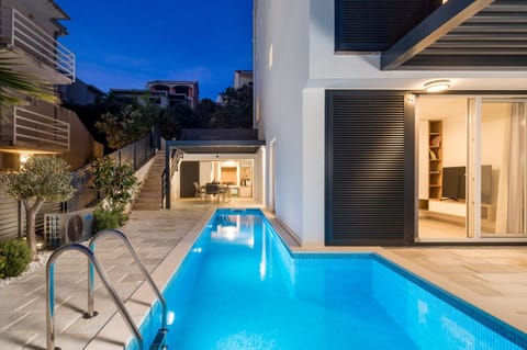 Property building, Patio, Night, Pool view, Swimming pool, sunbed