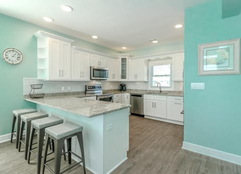 Kitchen or kitchenette, Seating area, furniture, microwave, stove, air conditioner
