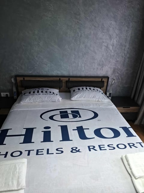 Bed, Property logo or sign, Photo of the whole room, Logo/Certificate/Sign, Bedroom, Text overlay, Certificate/Award