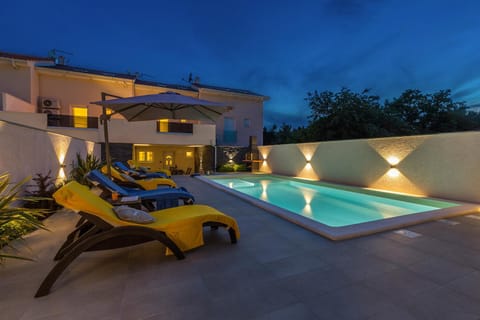Property building, Patio, Night, Swimming pool, sunbed