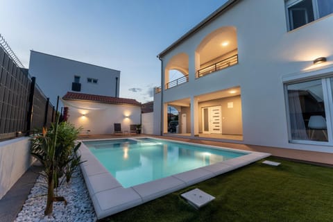 Property building, Patio, Pool view, Swimming pool, sunbed