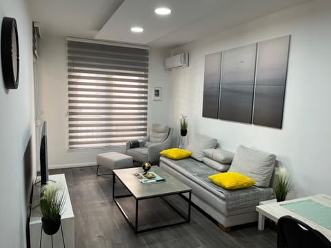 Bed, TV and multimedia, Living room, Seating area, air conditioner