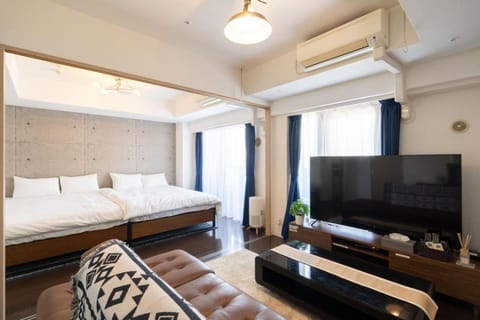 Bed, TV and multimedia, Living room, Seating area, Bedroom, air conditioner