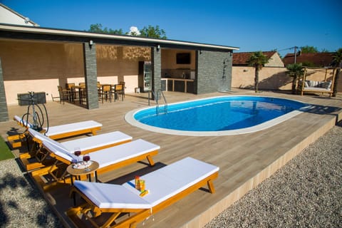 Property building, Patio, Pool view, Swimming pool, sunbed