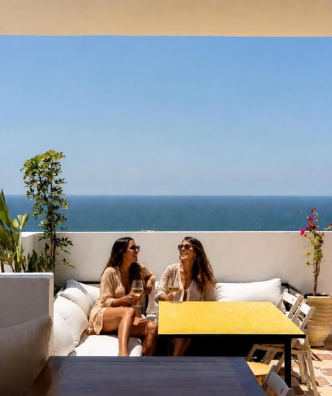 People, View (from property/room), Balcony/Terrace, Living room, Seating area, Dining area, Guests, Sea view, group of guests