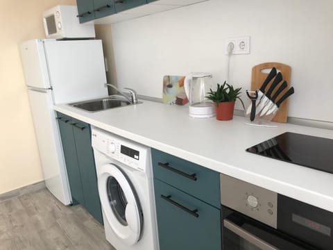 Kitchen or kitchenette, oven, stove, washing machine