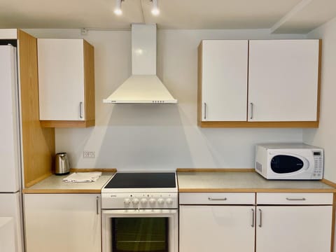 Kitchen or kitchenette, microwave, oven, stove
