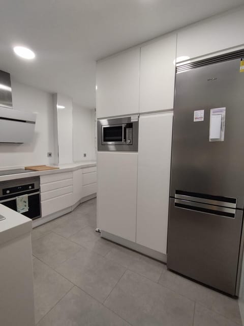 Kitchen or kitchenette, dishwasher, microwave, oven, stove, washing machine