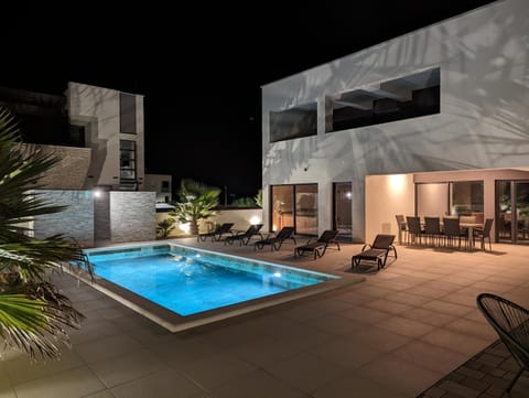Property building, Patio, Night, Pool view, Swimming pool, sunbed
