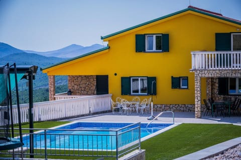 Property building, Patio, Day, Natural landscape, Pool view, sunbed
