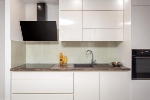 Kitchen or kitchenette, dishwasher, storage, stove