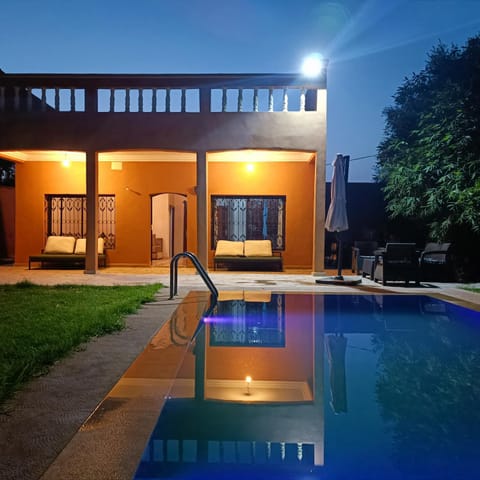 Property building, Patio, Night, Pool view, Swimming pool, Swimming pool, sunbed