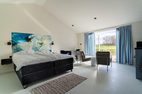Bed, TV and multimedia, Living room, Seating area, Bedroom