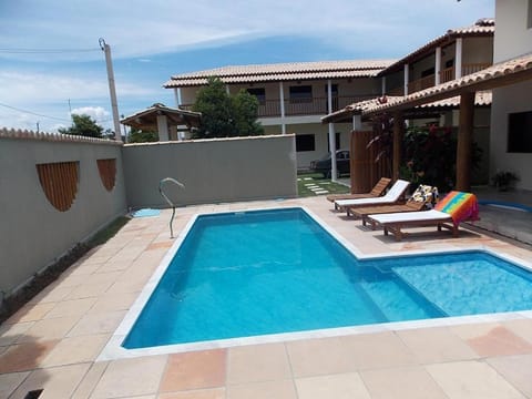 Property building, Patio, Pool view, Swimming pool, sunbed