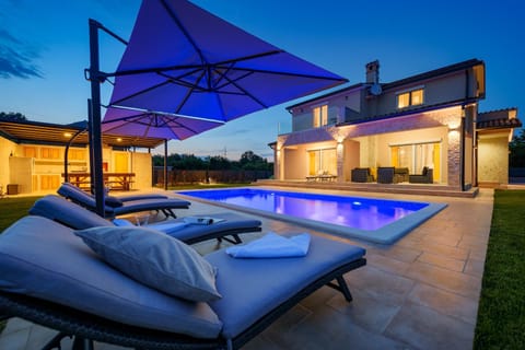 Property building, Patio, Natural landscape, Seating area, Beach, Pool view, sunbed