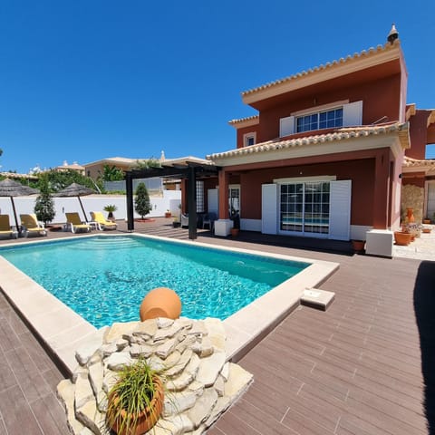 Property building, Patio, Pool view, Swimming pool, sunbed