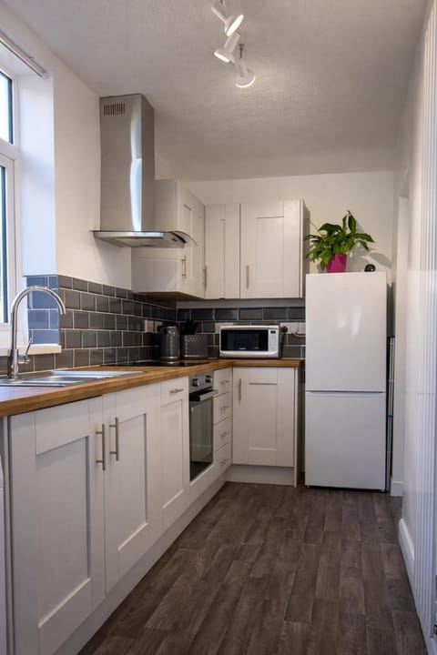 Kitchen or kitchenette, dishwasher, oven, stove