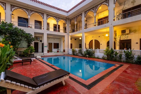 Property building, Patio, Pool view, Swimming pool, sunbed