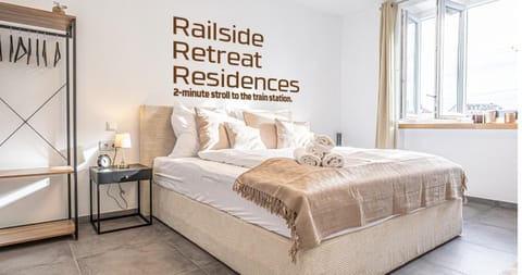 Bed, Photo of the whole room, Bedroom, Text overlay, towels