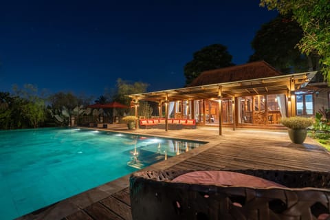 Property building, Patio, Night, Pool view, Swimming pool, sunbed