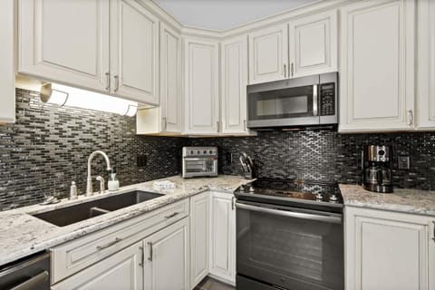 Kitchen or kitchenette, dishwasher, oven, stove, toaster