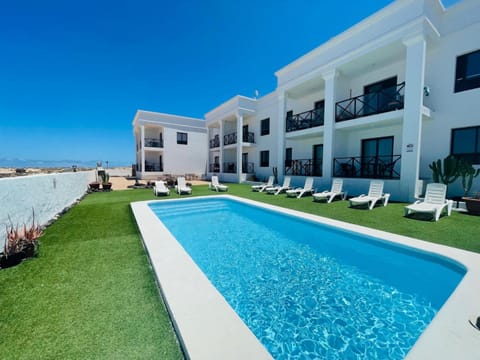 Property building, Patio, Pool view, Swimming pool, sunbed