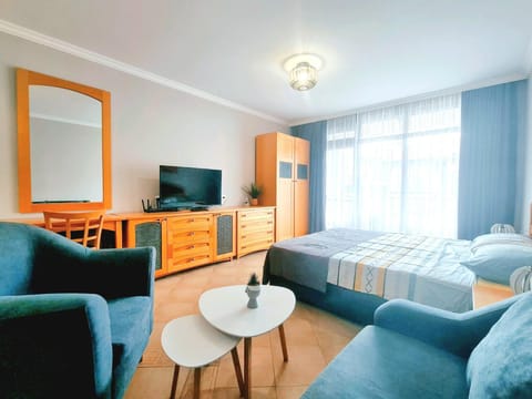 Bed, TV and multimedia, Living room, Seating area, Bedroom
