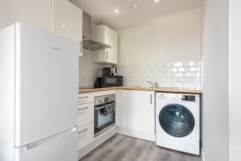 Kitchen or kitchenette, oven, stove, toaster, washing machine, dryer