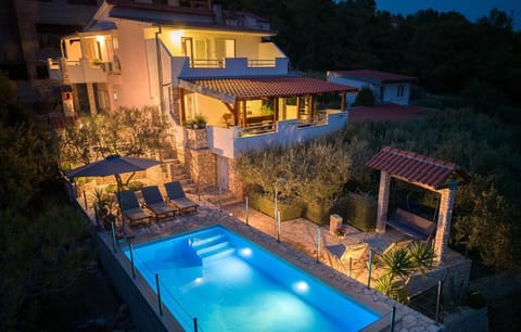 Property building, Patio, Night, Swimming pool, sunbed
