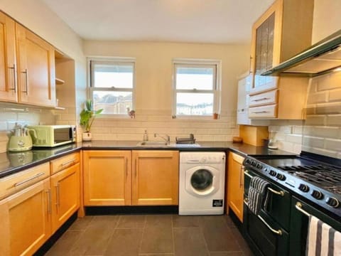 Kitchen or kitchenette, oven, stove, toaster, washing machine