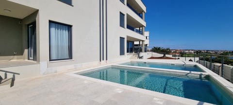 Property building, Pool view, Swimming pool, sunbed