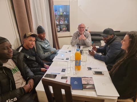 Communal lounge/ TV room, People, Living room, Seating area, group of guests